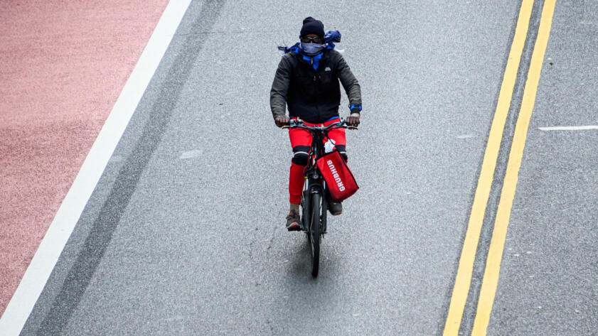 A Grubhub delivery person rides a bicycle on 42nd street during the coronavirus pandemic on May 18, 2020 in New York City.
