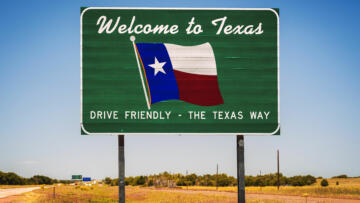 A photo of a road sign that reads "Welcome to Texas. Drive Friendly – The Texas Way"
