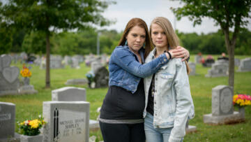 A photo of sisters Brittany Conway and Chelsey Shipley by the grave of their father Michael Shipley who died of a drug overdose