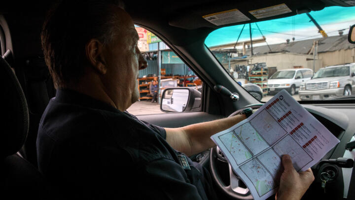 An LAPD officer on patrol with PredPol predictive maps