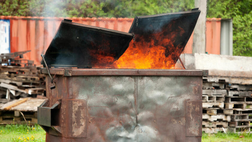 A photo of a dumpster on fire