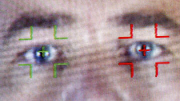 A closeup photo of a pair of eyes being scanned with facial recognition software