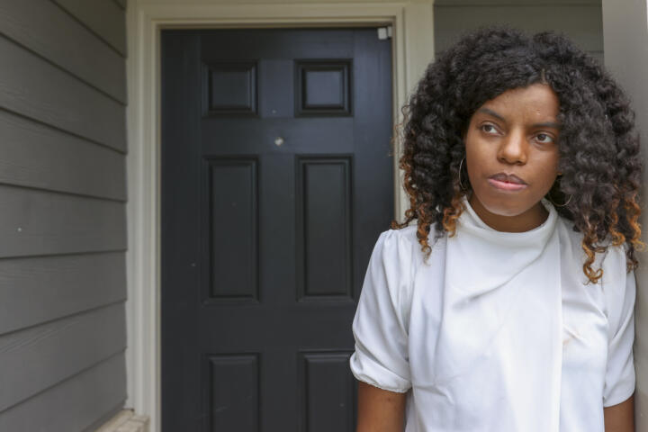 Crystal Marie McDaniels in front of the door of her Charlotte home.