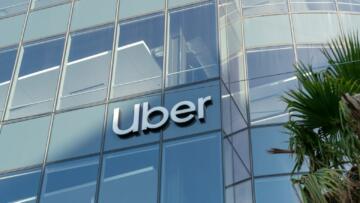 The Uber logo on glass facade of Uber headquarters