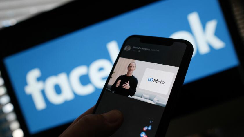 In this illustration photo taken in Los Angeles on October 28, 2021, a person watches on a smartphone Facebook CEO Mark Zuckerberg unveil the META logo.