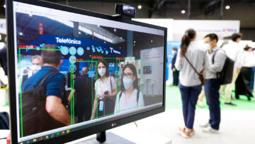 A computer monitor displays images of conference attendees digitally identified as people by an artificial intelligence camera.