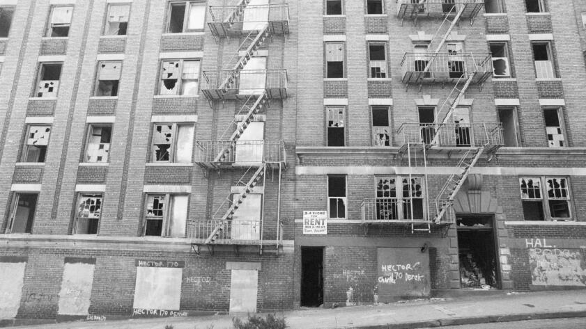 Black and white photograph of an abandoned apartment building