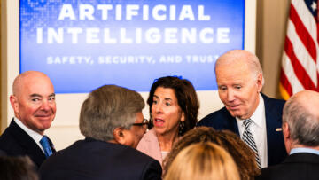 Photograph of US President Joe Biden chatting with guests during an event about his executive AI order