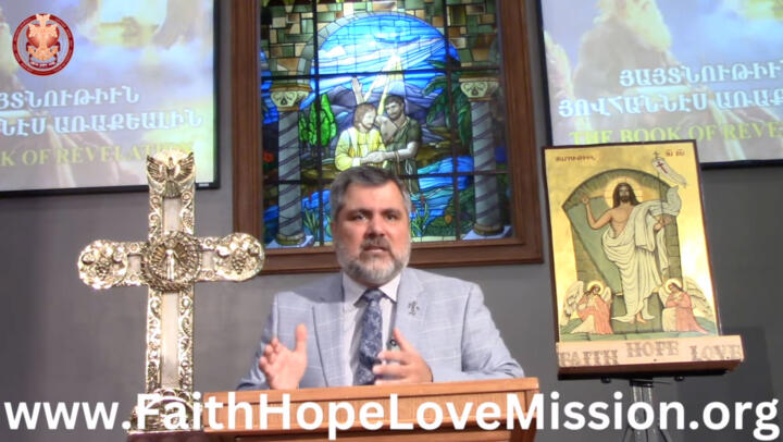Screenshot of a livestream of Barthev Gulumian preaching at a pulpit inside an Armenian Orthodox church; the bottom of the video displays the URL “www.FaithHopeLoveMission.org”