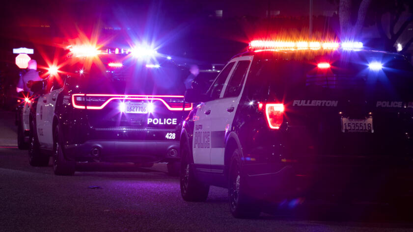 Photo of two Fullerton police cars at night