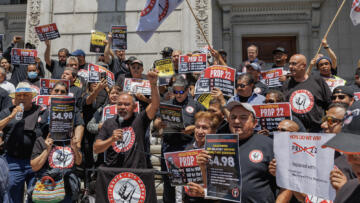 Ride-share driver and SEIU Gig Workers Union member John Mejia, center, speaks during a press conference outside of the Supreme Court of California in San Francisco on May 21, 2024. The state Supreme Court heard oral arguments on Prop. 22, a ballot initiative that allows ride-share companies, such as Uber and Lyft, to classify drivers as independent contractors.