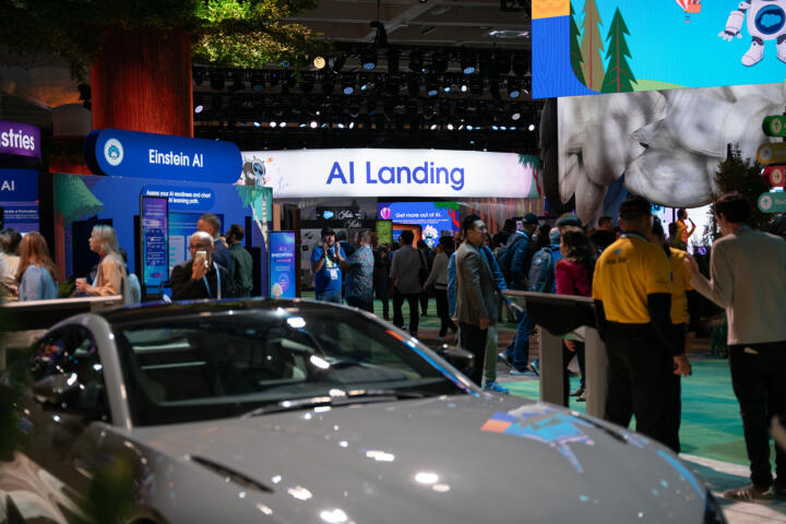 A conference hall with attendees and colorful signage related to artificial intelligence.